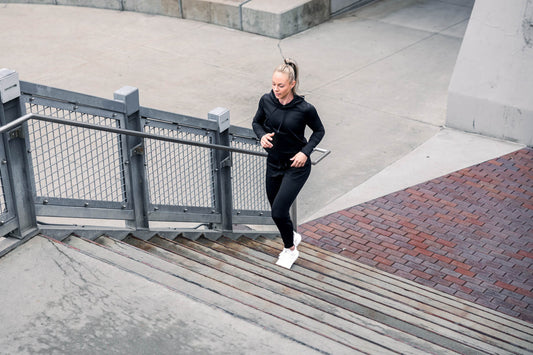 Athlete runs up a staircase in REP apparel.